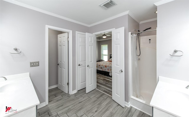 full bath featuring a shower with shower curtain, visible vents, wood finished floors, and vanity