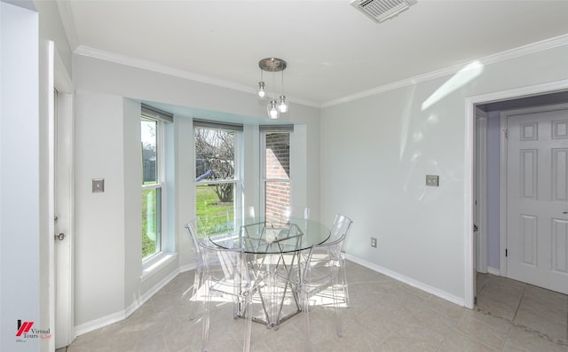 tiled dining room featuring ornamental molding and a wealth of natural light