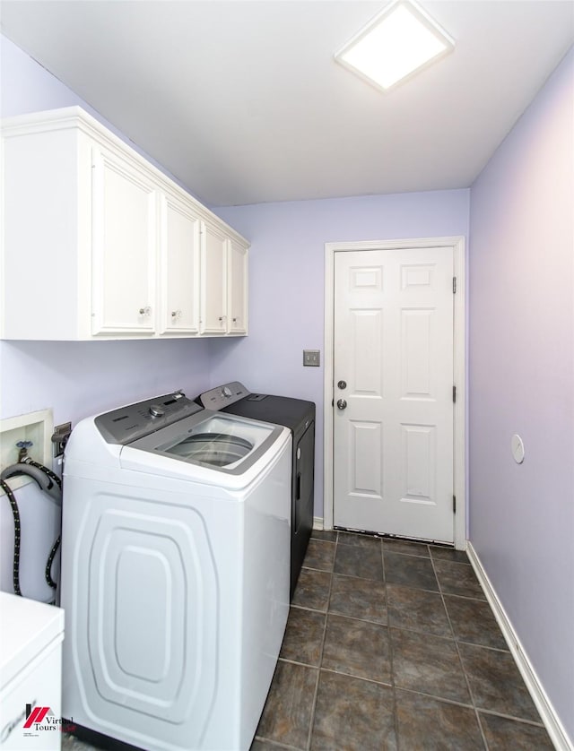 laundry room with washing machine and clothes dryer, cabinet space, and baseboards