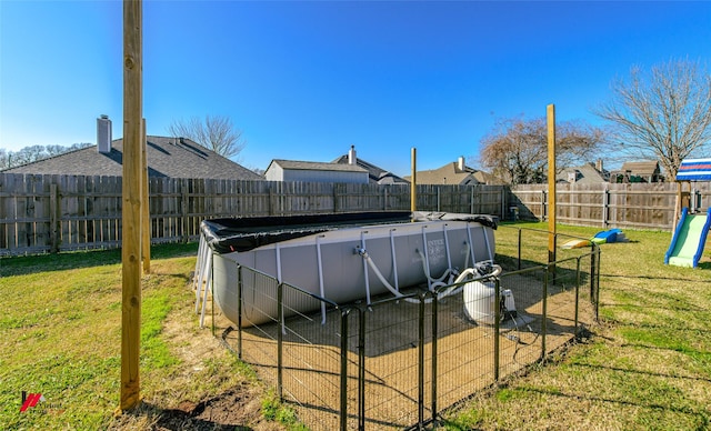 view of yard with a fenced in pool and a fenced backyard