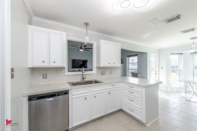 kitchen with kitchen peninsula, stainless steel dishwasher, decorative light fixtures, white cabinets, and sink