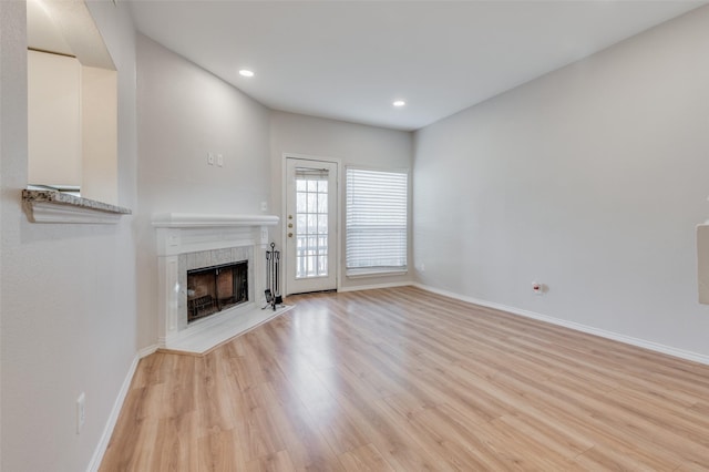 unfurnished living room featuring a fireplace and light wood-type flooring