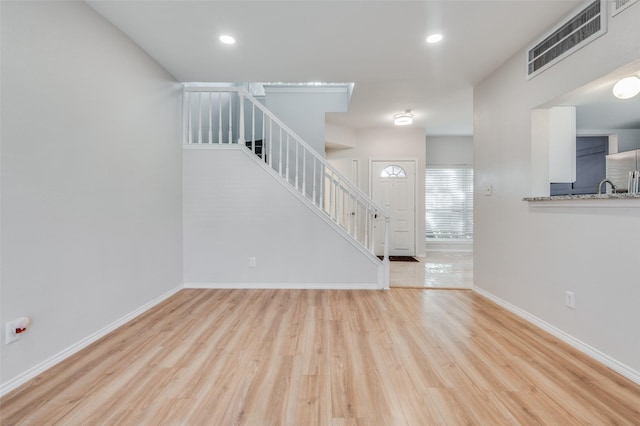 unfurnished living room featuring light hardwood / wood-style flooring