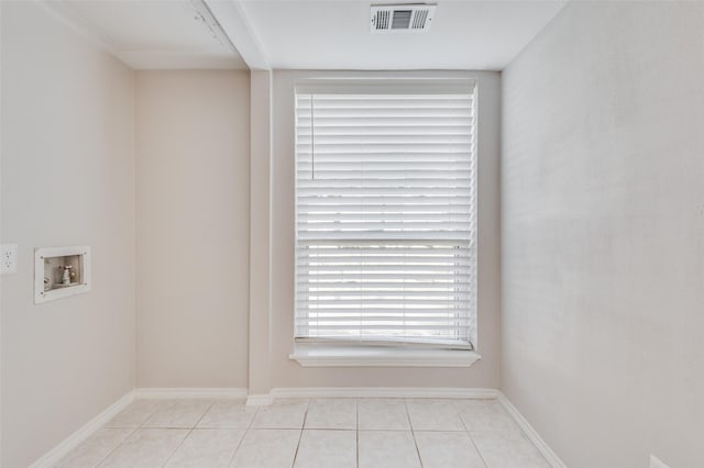 laundry area featuring hookup for a washing machine and light tile patterned floors