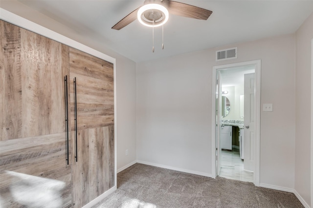 empty room featuring carpet floors and ceiling fan