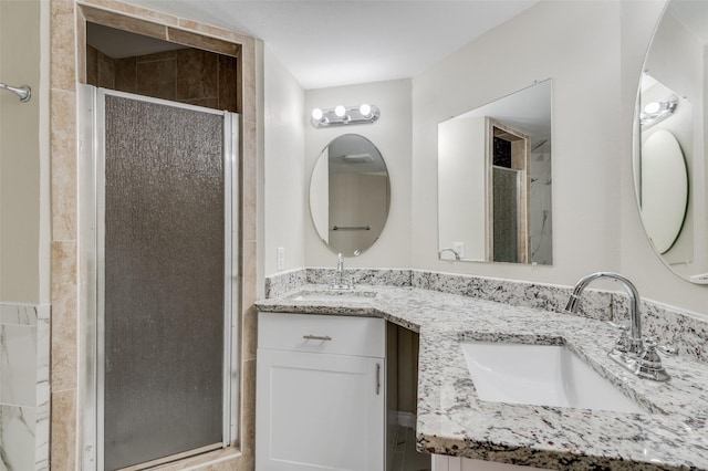 bathroom featuring walk in shower and vanity