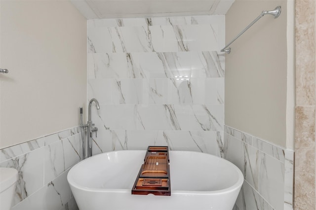 bathroom with tile walls and a bathing tub