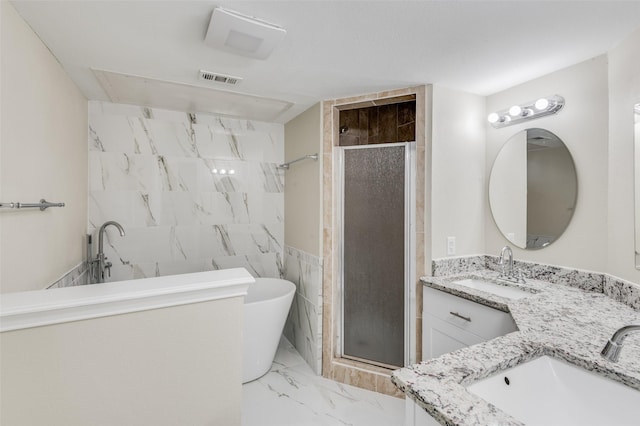 bathroom with tile walls, separate shower and tub, and vanity