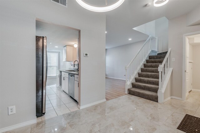 staircase with a premium fireplace and hardwood / wood-style floors