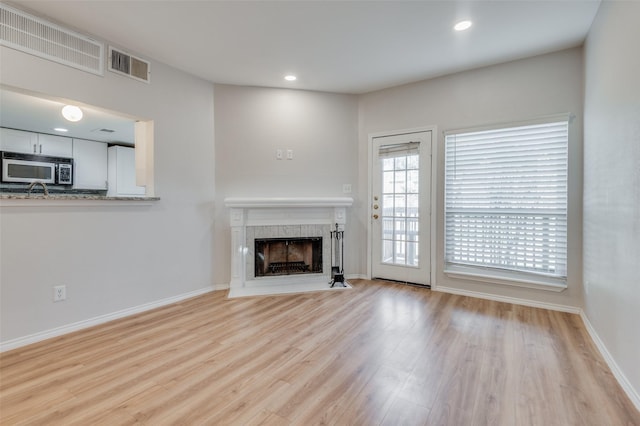 unfurnished living room with light hardwood / wood-style flooring