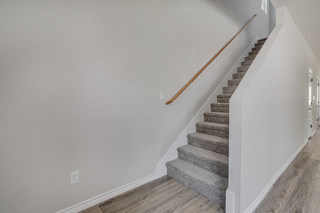 stairway featuring wood-type flooring