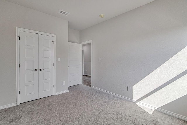 unfurnished bedroom with a closet and carpet