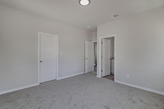 unfurnished bedroom featuring light colored carpet