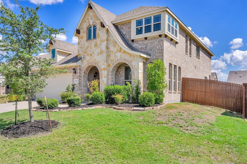 view of front of property with a front lawn and a garage