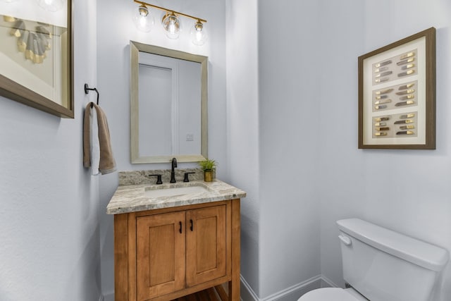 bathroom featuring toilet and vanity