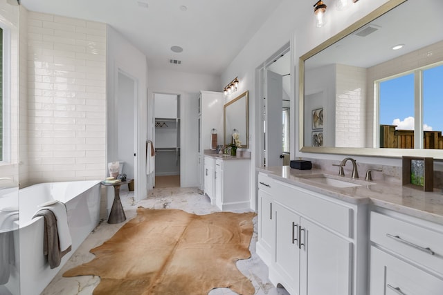 bathroom with a bath and vanity