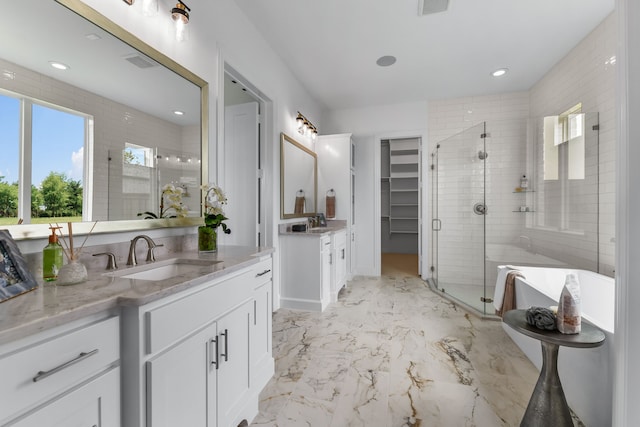 bathroom featuring independent shower and bath and vanity