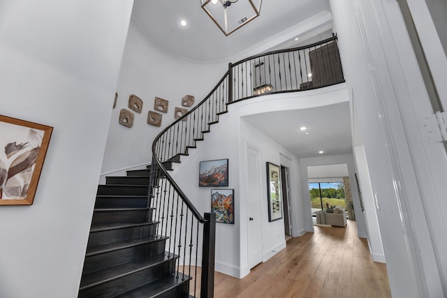 interior space featuring a towering ceiling and hardwood / wood-style flooring