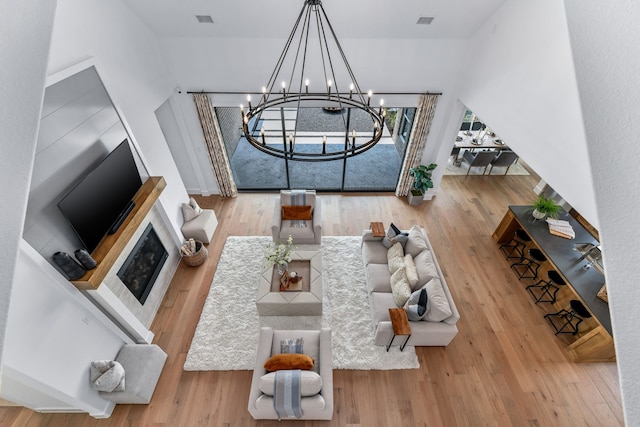 living room with an inviting chandelier and wood-type flooring