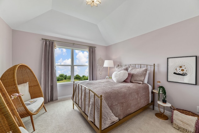 carpeted bedroom with lofted ceiling