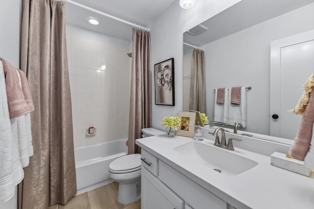 full bathroom featuring toilet, hardwood / wood-style floors, shower / bath combo, and vanity