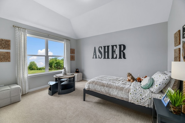 carpeted bedroom with lofted ceiling