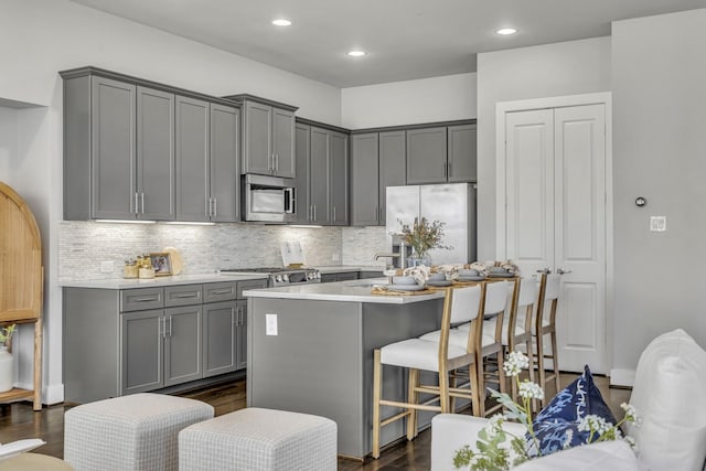 kitchen with a kitchen island, appliances with stainless steel finishes, and gray cabinets