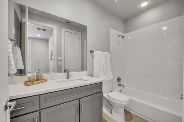 full bathroom featuring tile patterned floors, toilet, vanity, and tiled shower / bath