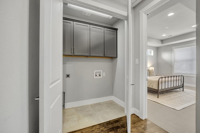 laundry area with tile patterned flooring, cabinets, hookup for an electric dryer, and washer hookup