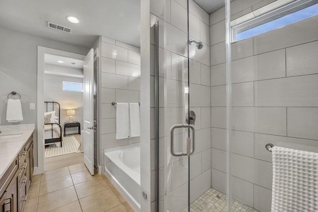 bathroom with independent shower and bath, tile patterned floors, and vanity