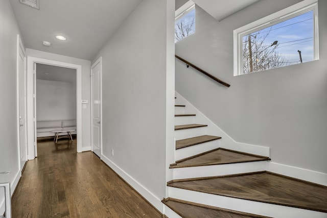 stairs featuring hardwood / wood-style flooring