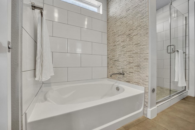 bathroom featuring tile patterned flooring and separate shower and tub