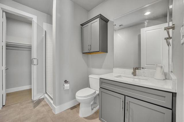 bathroom with a shower with door, tile patterned flooring, vanity, and toilet