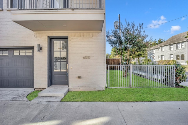 entrance to property with a yard and a garage