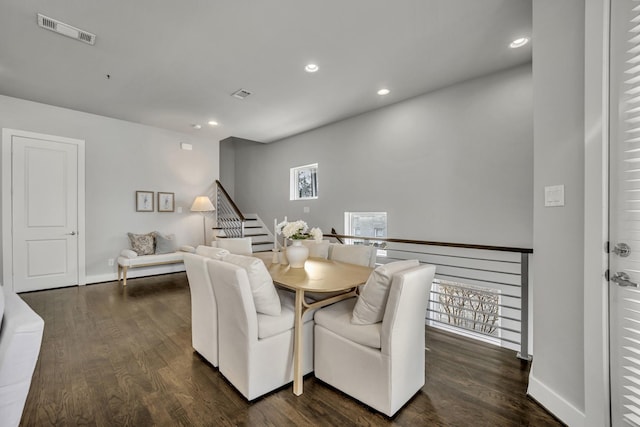 dining space with dark hardwood / wood-style floors