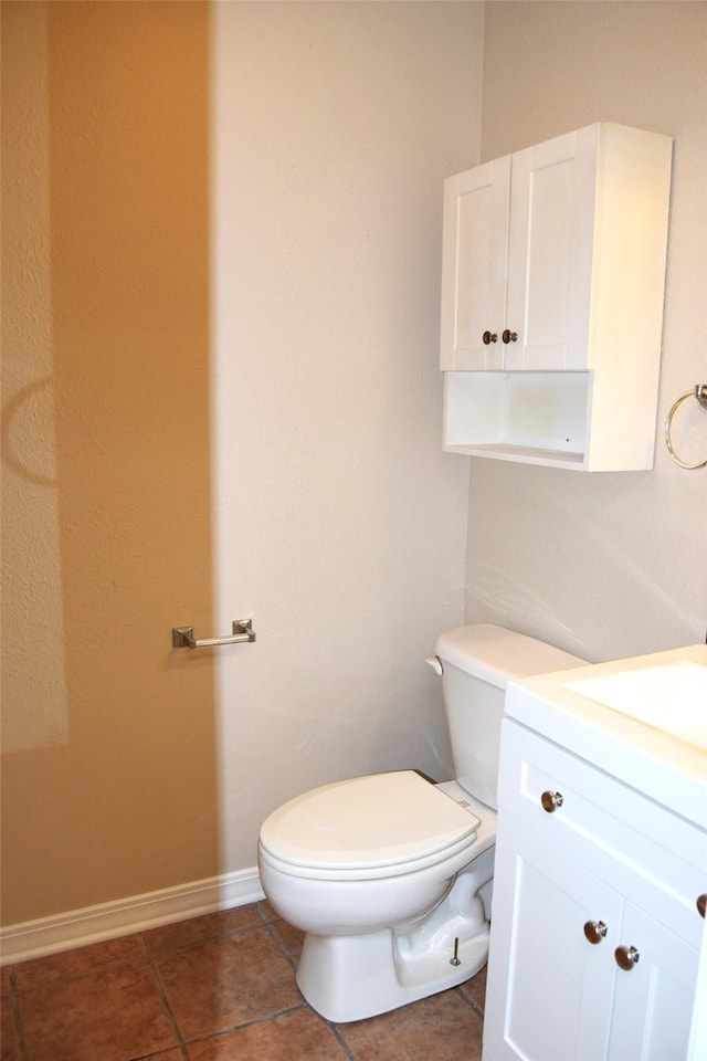 bathroom featuring toilet, vanity, and tile patterned floors