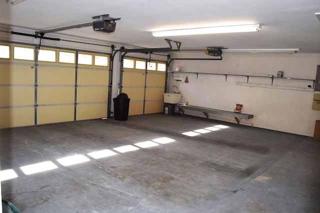 garage featuring a garage door opener and sink