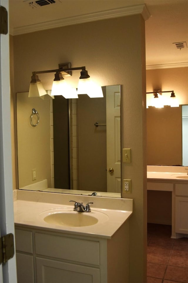 bathroom with ornamental molding, tile patterned floors, and vanity