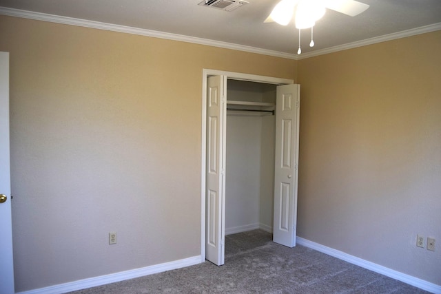 unfurnished bedroom featuring carpet floors, ceiling fan, crown molding, and a closet