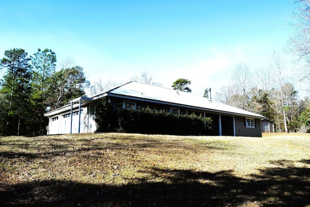 exterior space with a yard and a garage