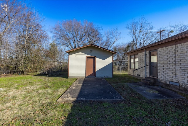 view of outbuilding featuring a lawn