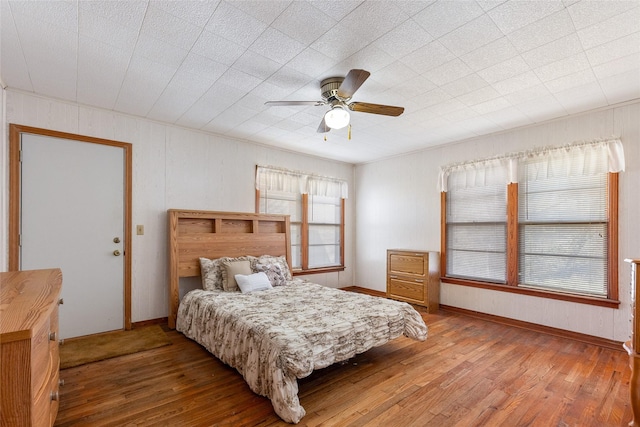 bedroom with ceiling fan and hardwood / wood-style floors