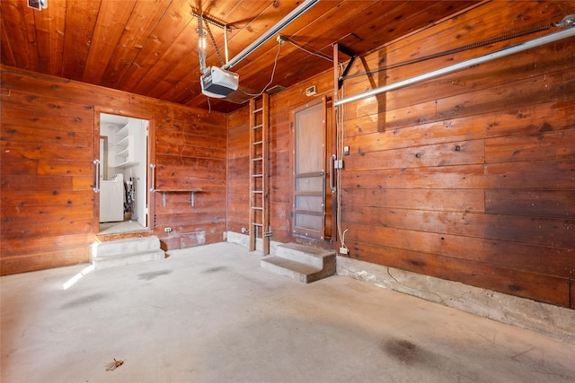 garage with wooden ceiling, wood walls, and a garage door opener