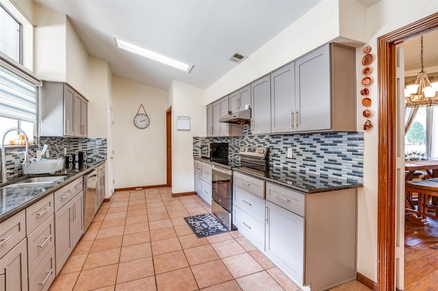 kitchen featuring appliances with stainless steel finishes, light tile patterned flooring, gray cabinetry, and sink