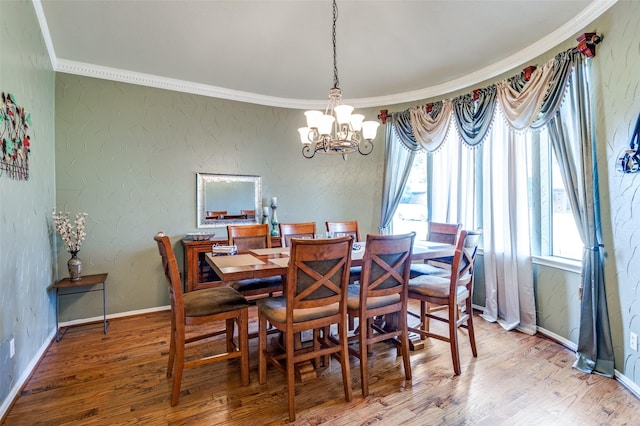 dining space with an inviting chandelier, ornamental molding, and wood-type flooring