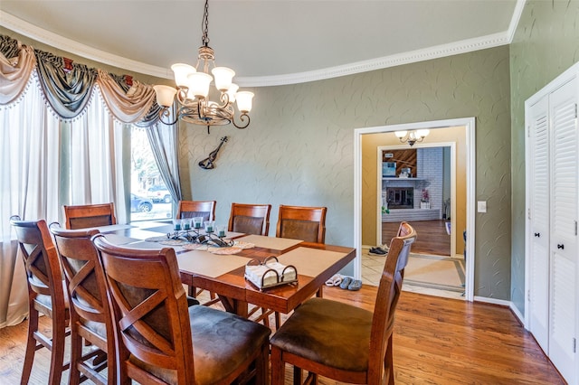 dining room with ornamental molding, hardwood / wood-style floors, and a notable chandelier