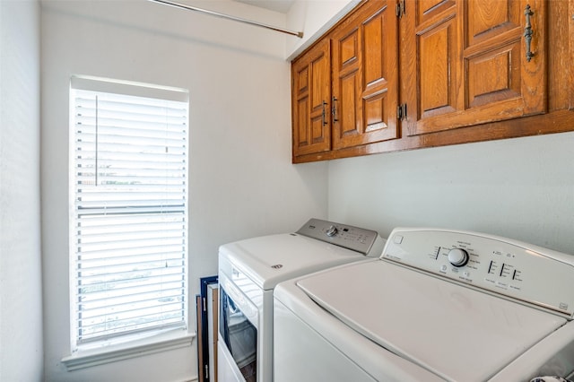 laundry room with washer and dryer and cabinets