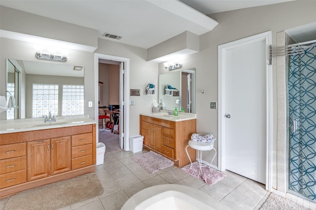 bathroom with tile patterned floors, walk in shower, and vanity