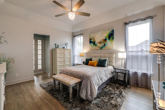 bedroom with wood-type flooring and ceiling fan