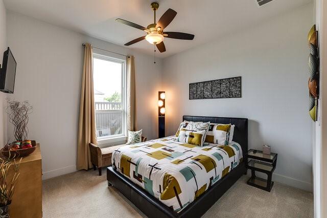 carpeted bedroom with ceiling fan